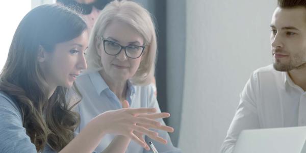 A woman explaining something to a group of people